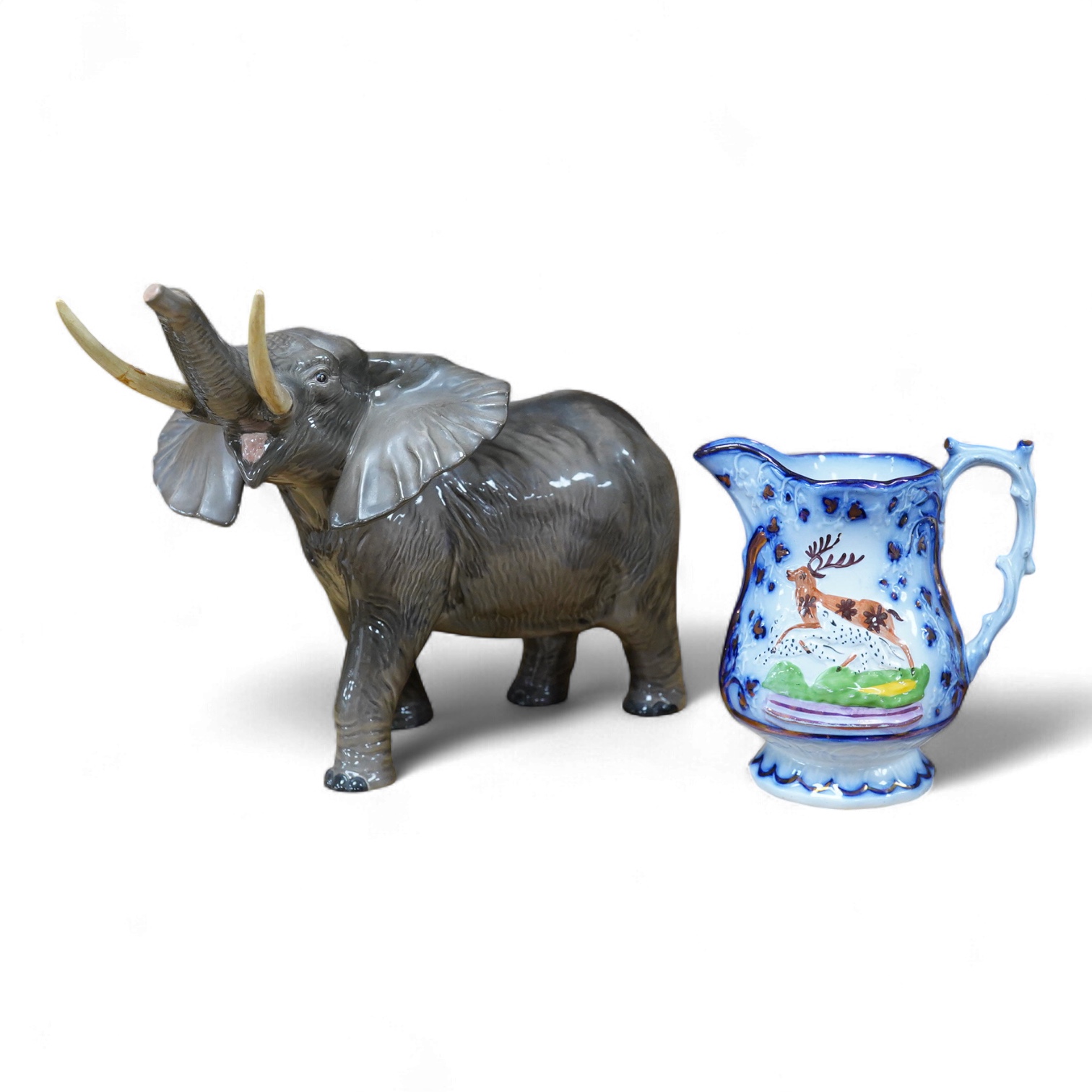 A Beswick model of an elephant and a Staffordshire jug, c.1840, largest 34cm wide